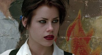 Movie still from “The Craft” (1996), directed by Andrew Fleming – A person wearing a white shirt; Close Up shot, Low angle