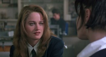 Movie still from “The Craft” (1996), directed by Andrew Fleming – A woman in a suit is talking to another woman; Close Up shot, Over the shoulder angle