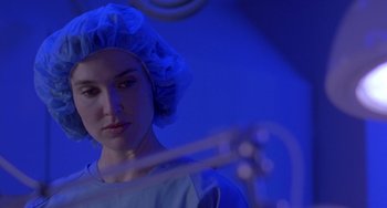 Movie still from “The Craft” (1996), directed by Andrew Fleming – A woman wearing a surgical cap and a white shirt; Close Up shot, Low angle