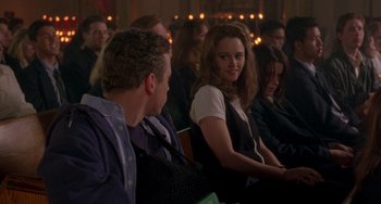 Movie still from “The Craft” (1996), directed by Andrew Fleming – A group of young people sitting in a room together; Medium shot, Over the shoulder angle