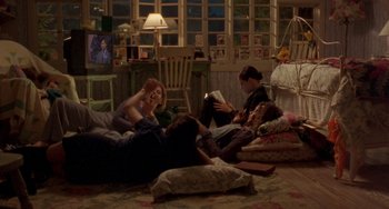 Movie still from “The Craft” (1996), directed by Andrew Fleming – A group of people sitting in a living room; Wide shot, High angle