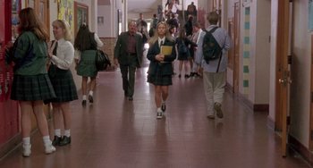 Movie still from “The Craft” (1996), directed by Andrew Fleming – A group of people walking down a hall way; Wide shot, High angle