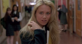 Movie still from “The Craft” (1996), directed by Andrew Fleming – A young blond haired woman posing for a picture; Close Up shot, Over the shoulder angle