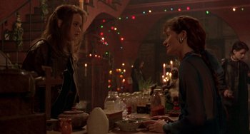 Movie still from “The Craft” (1996), directed by Andrew Fleming – Two women are sitting at a table talking to each other; Medium shot, Over the shoulder angle