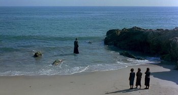 Movie still from “The Craft” (1996), directed by Andrew Fleming – Two people standing on the beach looking out at the ocean; Extreme Wide shot, High angle