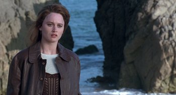 Movie still from “The Craft” (1996), directed by Andrew Fleming – A woman standing in front of a body of water; Close Up shot, Over the shoulder angle