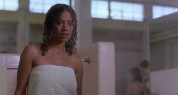 Movie still from “The Craft” (1996), directed by Andrew Fleming – A woman in a white towel in a bathroom next to a shower; Close Up shot, Over the shoulder angle