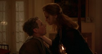 Movie still from “The Craft” (1996), directed by Andrew Fleming – A man and a woman are looking into each others eyes; Medium shot, Over the shoulder angle