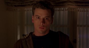 Movie still from “The Craft” (1996), directed by Andrew Fleming – A person wearing a black t - shirt; Close Up shot, Low angle