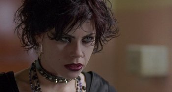 Movie still from “The Craft” (1996), directed by Andrew Fleming – A person wearing a necklace and looking at the camera; Close Up shot, Over the shoulder angle