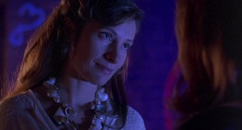Movie still from “The Craft” (1996), directed by Andrew Fleming – A young woman wearing a white shirt and a necklace; Close Up shot, Over the shoulder angle