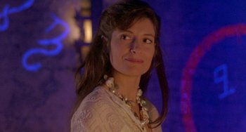 A woman with long brown hair wearing a white dress