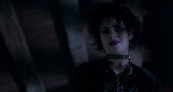Movie still from “The Craft” (1996), directed by Andrew Fleming – A person wearing a necklace; Close Up shot, Over the shoulder angle