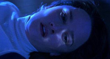 Movie still from “The Craft” (1996), directed by Andrew Fleming – A person laying on the ground at night; Close Up shot, Overhead angle