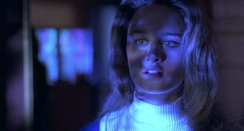 Movie still from “The Craft” (1996), directed by Andrew Fleming – A woman with long brown hair wearing a white sweater; Close Up shot, Low angle