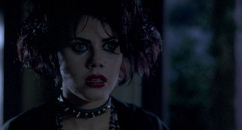 Movie still from “The Craft” (1996), directed by Andrew Fleming – A person wearing a hat and a necklace; Close Up shot, Over the shoulder angle