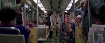 Movie still from “Casualties of War” (1989), directed by Brian De Palma – A group of people riding on a train; Wide shot, High angle
