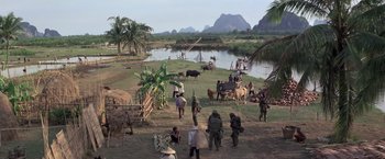 Movie still from “Casualties of War” (1989), directed by Brian De Palma – A group of people standing next to a body of water; Extreme Wide shot, High angle