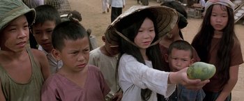 Movie still from “Casualties of War” (1989), directed by Brian De Palma – A group of young people standing next to each other on a dirt field; Close Up shot, High angle