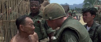 Movie still from “Casualties of War” (1989), directed by Brian De Palma – A man in a helmet is talking to an older man; Close Up shot, Over the shoulder angle