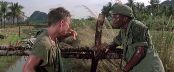Movie still from “Casualties of War” (1989), directed by Brian De Palma – Two men are fighting in a field; Medium shot, Over the shoulder angle