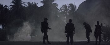 Movie still from “Casualties of War” (1989), directed by Brian De Palma – Two men standing in front of a palm tree forest; Extreme Wide shot, Low angle