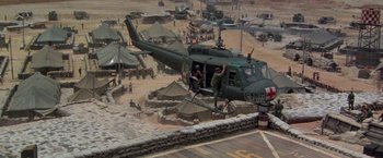 Movie still from “Casualties of War” (1989), directed by Brian De Palma – A helicopter is parked on the side of the road; Extreme Wide shot, High angle