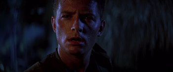 Movie still from “Casualties of War” (1989), directed by Brian De Palma – A man's face in the dark; Close Up shot, Low angle