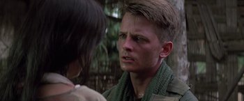 Movie still from “Casualties of War” (1989), directed by Brian De Palma – A young man is looking at a woman; Close Up shot, Over the shoulder angle
