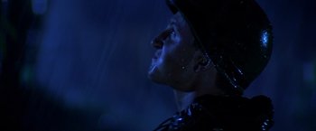Movie still from “Casualties of War” (1989), directed by Brian De Palma – A person wearing a rain jacket; Close Up shot, Low angle