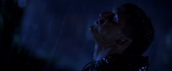 Movie still from “Casualties of War” (1989), directed by Brian De Palma – A man with his eyes closed and his mouth open in the rain; Close Up shot, Low angle
