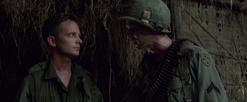Movie still from “Casualties of War” (1989), directed by Brian De Palma – A man and a woman in military fatigues; Close Up shot, Over the shoulder angle