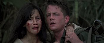 Movie still from “Casualties of War” (1989), directed by Brian De Palma – A man and a woman are crying in the woods; Close Up shot, Low angle
