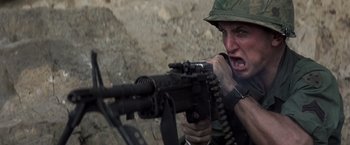 Movie still from “Casualties of War” (1989), directed by Brian De Palma – A man with a gun in his hands; Close Up shot, Low angle