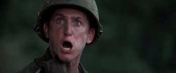 Movie still from “Casualties of War” (1989), directed by Brian De Palma – A man wearing a helmet with his mouth wide open; Close Up shot, Low angle