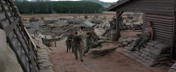 Movie still from “Casualties of War” (1989), directed by Brian De Palma – A group of men in fatigues are playing a game; Extreme Wide shot, High angle