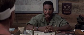 Movie still from “Casualties of War” (1989), directed by Brian De Palma – A man sitting at a table in front of a map; Close Up shot, High angle