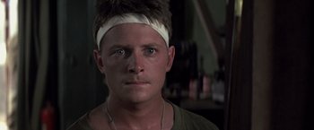 Movie still from “Casualties of War” (1989), directed by Brian De Palma – A person wearing a headband; Close Up shot, Low angle