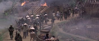 Movie still from “Casualties of War” (1989), directed by Brian De Palma – A group of people in the middle of a field; Extreme Wide shot, High angle