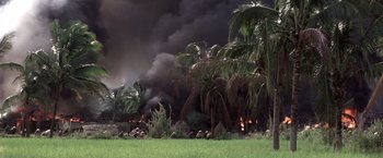 Movie still from “Casualties of War” (1989), directed by Brian De Palma – A fire burning in the middle of a field; Extreme Wide shot, High angle