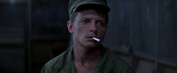 Movie still from “Casualties of War” (1989), directed by Brian De Palma – A man with a cigarette in his mouth; Close Up shot, Low angle