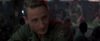 Movie still from “Casualties of War” (1989), directed by Brian De Palma – A person wearing a military uniform; Close Up shot, Over the shoulder angle