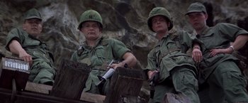 Movie still from “Casualties of War” (1989), directed by Brian De Palma – A couple of men standing next to each other; Medium shot, Low angle