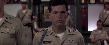 Movie still from “Casualties of War” (1989), directed by Brian De Palma – A man in a military uniform is looking at the camera; Close Up shot, Low angle
