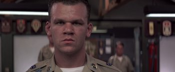 Movie still from “Casualties of War” (1989), directed by Brian De Palma – A person wearing a military uniform; Close Up shot, Low angle