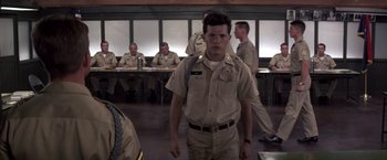 Movie still from “Casualties of War” (1989), directed by Brian De Palma – A man in uniform standing in front of a group of people; Medium shot, Low angle