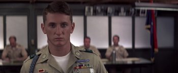 Movie still from “Casualties of War” (1989), directed by Brian De Palma – A man in a military uniform standing in front of two other men; Close Up shot, Low angle