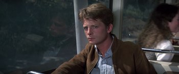 Movie still from “Casualties of War” (1989), directed by Brian De Palma – A man sitting in front of a window with his eyes closed; Close Up shot, Over the shoulder angle