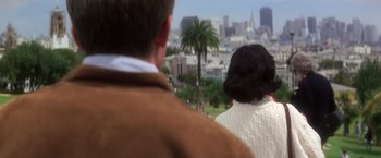 Movie still from “Casualties of War” (1989), directed by Brian De Palma – A man and a woman looking out over a city; Medium shot, Over the shoulder angle