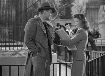 Movie still from “Cat People” (1942), directed by Jacques Tourneur – A man and a woman standing next to each other; Medium shot, High angle